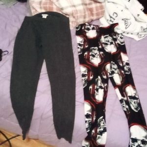 Gray leggings black leggings with skulls wearing red headphones size is small.
